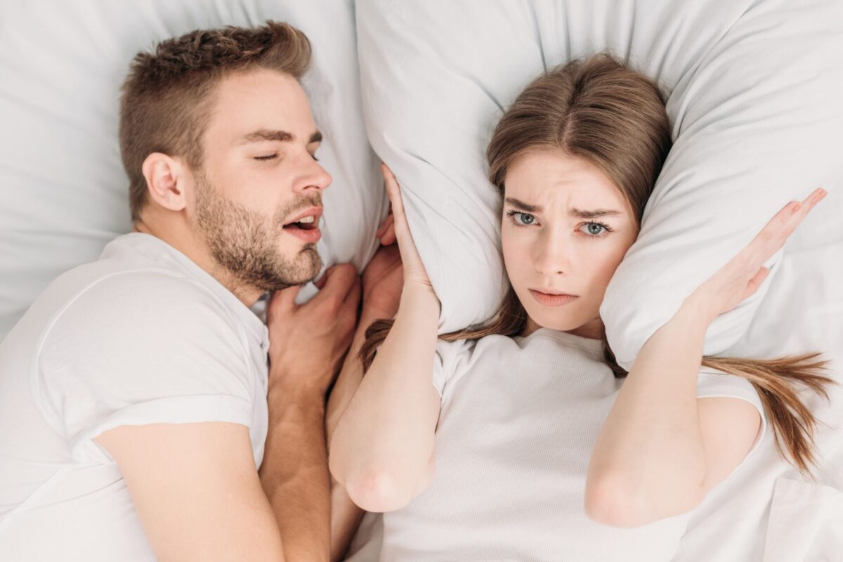 top-view-of-woman-plugging-ears-with-pillow-while-2023-11-27-05-22-13-utc (1)